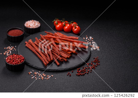 Jerky dried fish sticks with salt and spices 125426292