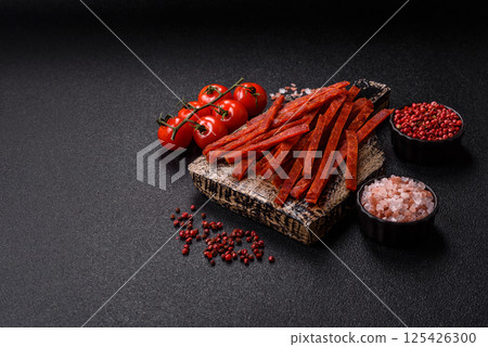 Jerky dried fish sticks with salt and spices 125426300