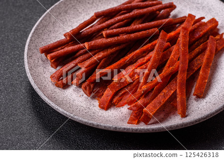 Jerky dried fish sticks with salt and spices 125426318