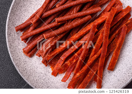 Jerky dried fish sticks with salt and spices 125426319