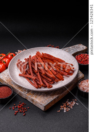 Jerky dried fish sticks with salt and spices Jerky dried fish sticks with salt and spices 125426341