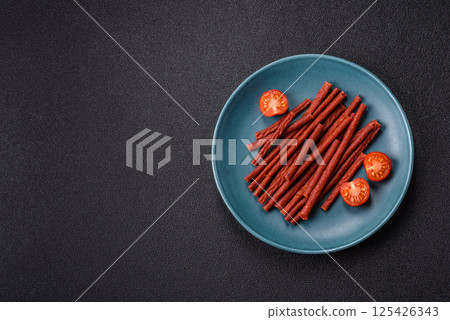 Jerky dried fish sticks with salt and spices 125426343