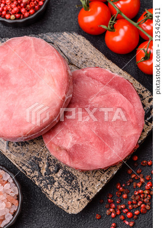 Two fresh slices of raw tuna fillet with spices and herbs 125426411