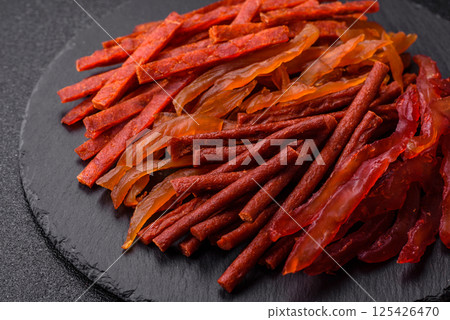 Jerky, dried fish in the form of sticks with salt, spices and herbs Jerky, dried fish in the form of sticks with salt, spices and herbs 125426470