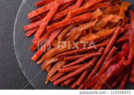Jerky, dried fish in the form of sticks with salt, spices and herbs Jerky, dried fish in the form of sticks with salt, spices and herbs 125426471