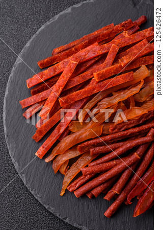 Jerky, dried fish in the form of sticks with salt, spices and herbs Jerky, dried fish in the form of sticks with salt, spices and herbs 125426472