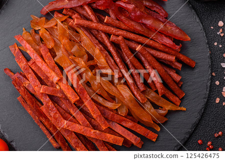 Jerky, dried fish in the form of sticks with salt, spices and herbs 125426475