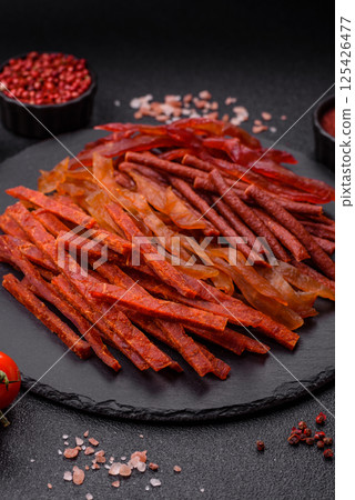 Jerky, dried fish in the form of sticks with salt, spices and herbs Jerky, dried fish in the form of sticks with salt, spices and herbs 125426477