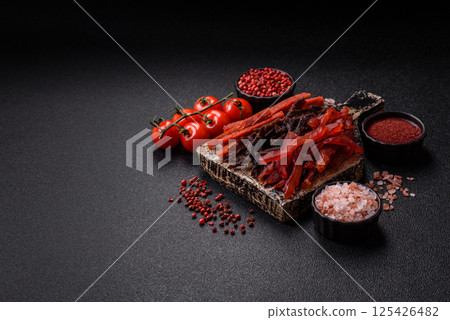 Jerky, dried fish in the form of sticks with salt, spices and herbs Jerky, dried fish in the form of sticks with salt, spices and herbs 125426482