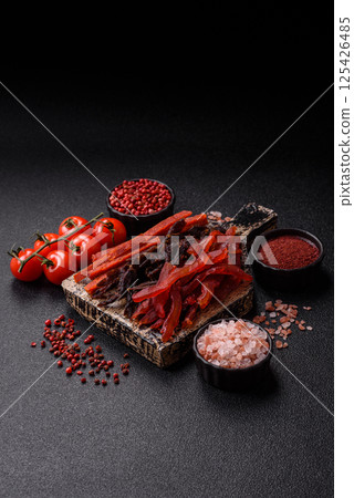 Jerky, dried fish in the form of sticks with salt, spices and herbs Jerky, dried fish in the form of sticks with salt, spices and herbs 125426485
