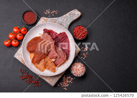 Jerky, dried meat in the form of slices with salt, spices and herbs 125426570