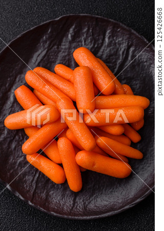 Raw peeled mini baby carrots as an ingredient for preparing a vegetarian food Raw peeled mini baby carrots as an ingredient for preparing a vegetarian food 125426668