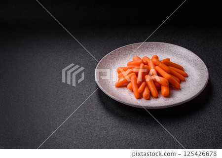 Raw peeled mini baby carrots as an ingredient for preparing a vegetarian food Raw peeled mini baby carrots as an ingredient for preparing a vegetarian food 125426678