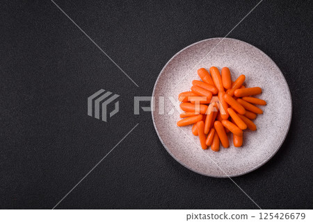 Raw peeled mini baby carrots as an ingredient for preparing a vegetarian food Raw peeled mini baby carrots as an ingredient for preparing a vegetarian food 125426679