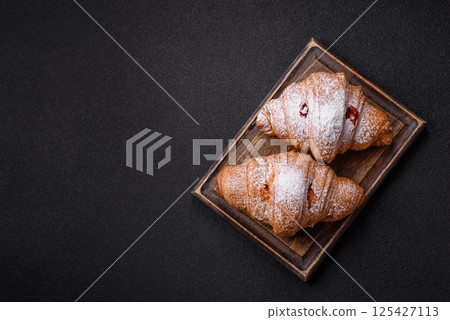 Sweet fresh crispy croissant with fruit filling Sweet fresh crispy croissant with fruit filling 125427113