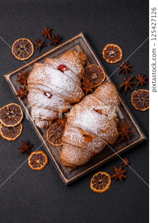 Sweet fresh crispy croissant with fruit filling Sweet fresh crispy croissant with fruit filling 125427126
