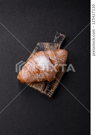 Sweet fresh crispy croissant with fruit filling Sweet fresh crispy croissant with fruit filling 125427130