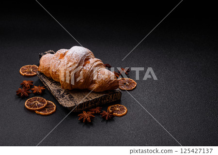 Sweet fresh crispy croissant with fruit filling 125427137