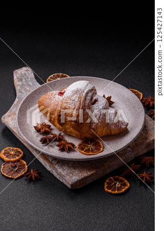 Sweet fresh crispy croissant with fruit filling Sweet fresh crispy croissant with fruit filling 125427143