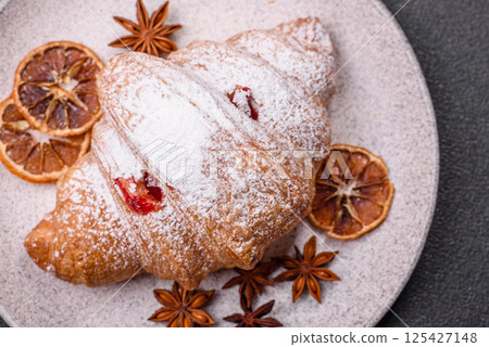 Sweet fresh crispy croissant with fruit filling Sweet fresh crispy croissant with fruit filling 125427148