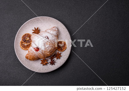 Sweet fresh crispy croissant with fruit filling Sweet fresh crispy croissant with fruit filling 125427152