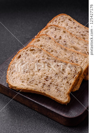 Brown bread with grains and seeds Brown bread with grains and seeds 125427176