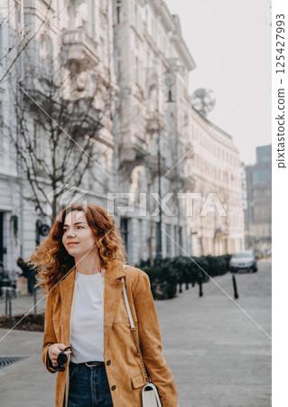 Young traveler embracing slow urban exploration on a peaceful city street. Mindful tourism, local culture, and relaxed digital lifestyle... 125427993