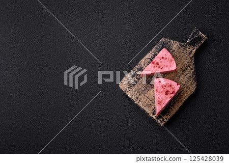A piece of sweet cheesecake with raspberry or strawberry flavor 125428039