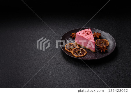 A piece of sweet cheesecake with raspberry or strawberry flavor 125428052