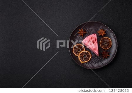 A piece of sweet cheesecake with raspberry or strawberry flavor A piece of sweet cheesecake with raspberry or strawberry flavor 125428053