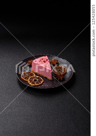 A piece of sweet cheesecake with raspberry or strawberry flavor A piece of sweet cheesecake with raspberry or strawberry flavor 125428055