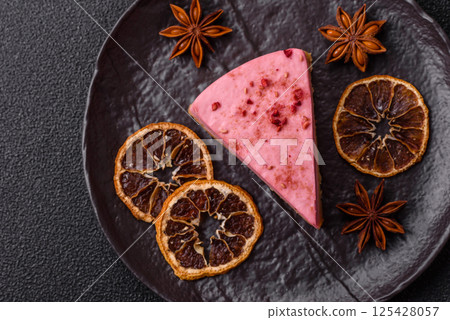 A piece of sweet cheesecake with raspberry or strawberry flavor 125428057