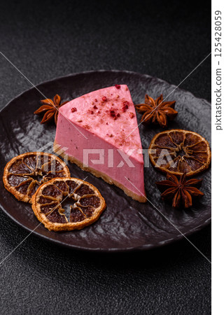 A piece of sweet cheesecake with raspberry or strawberry flavor 125428059