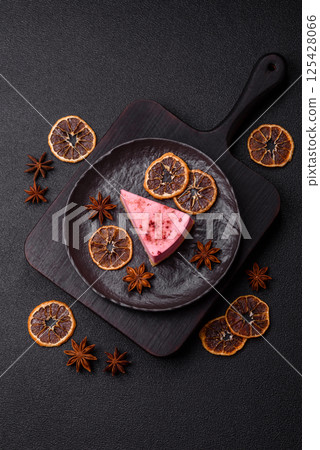 A piece of sweet cheesecake with raspberry or strawberry flavor A piece of sweet cheesecake with raspberry or strawberry flavor 125428066