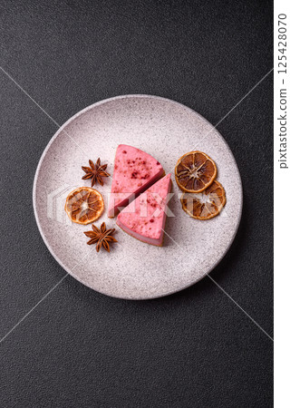 A piece of sweet cheesecake with raspberry or strawberry flavor A piece of sweet cheesecake with raspberry or strawberry flavor 125428070