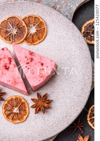 A piece of sweet cheesecake with raspberry or strawberry flavor A piece of sweet cheesecake with raspberry or strawberry flavor 125428077