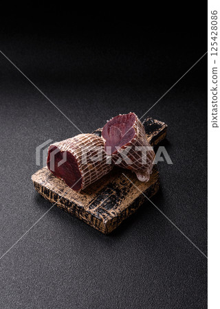 Smoked horse meat with salt, spices and herbs Smoked horse meat with salt, spices and herbs 125428086