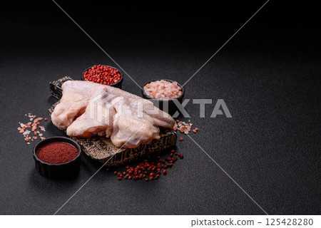 Raw chicken wings with salt, spices and herbs 125428280