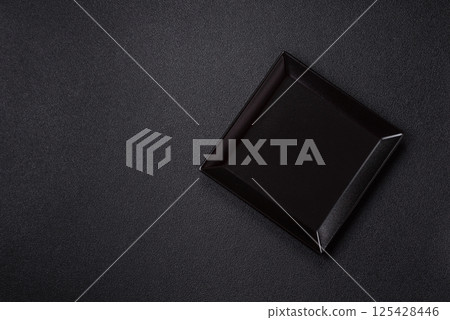 Empty ceramic round plate on dark textured concrete background 125428446