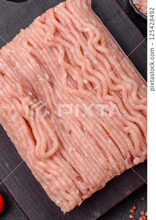 Raw minced chicken with salt, spices and herbs Raw minced chicken with salt, spices and herbs 125428492