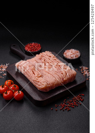 Raw minced chicken with salt, spices and herbs Raw minced chicken with salt, spices and herbs 125428497