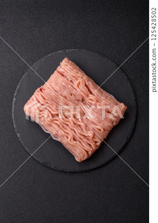 Raw minced chicken with salt, spices and herbs Raw minced chicken with salt, spices and herbs 125428502
