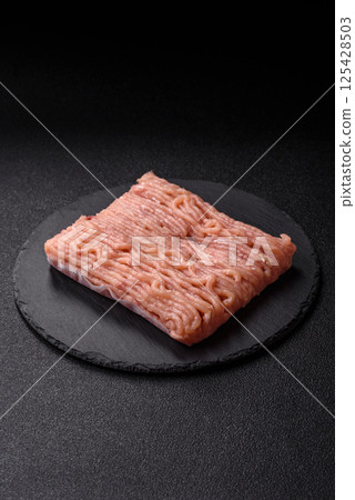 Raw minced chicken with salt, spices and herbs Raw minced chicken with salt, spices and herbs 125428503