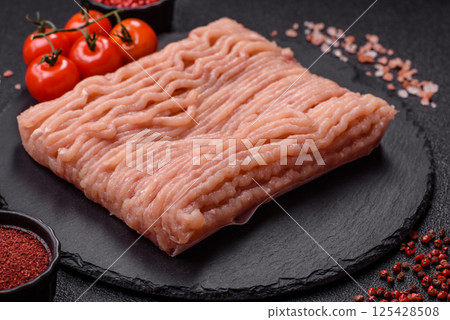 Raw minced chicken with salt, spices and herbs 125428508