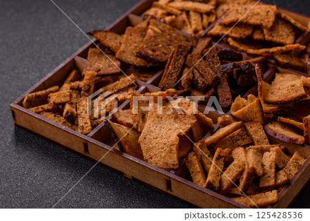 Crispy homemade brown bread chips with seeds and grains Crispy homemade brown bread chips with seeds and grains 125428536