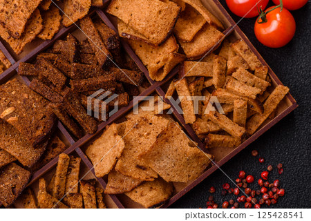 Crispy homemade brown bread chips with seeds and grains Crispy homemade brown bread chips with seeds and grains 125428541