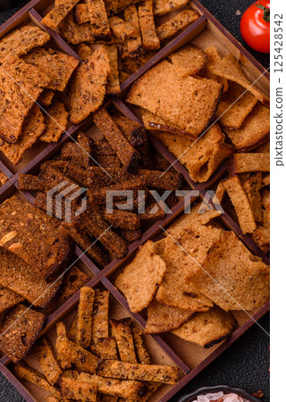 Crispy homemade brown bread chips with seeds and grains Crispy homemade brown bread chips with seeds and grains 125428542