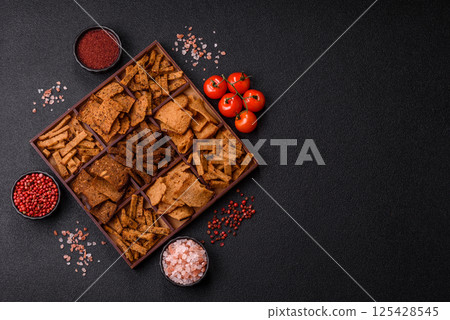 Crispy homemade brown bread chips with seeds and grains Crispy homemade brown bread chips with seeds and grains 125428545
