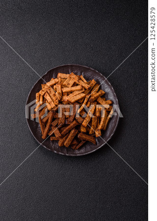 Crispy homemade brown bread crackers or croutons with seeds and grains 125428579