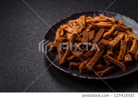 Crispy homemade brown bread crackers or croutons with seeds and grains Crispy homemade brown bread crackers or croutons with seeds and grains 125428581